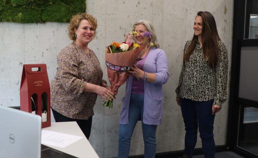 Dionne Eijdems en Maya Gloudemans overhandigen bloemen aan Anita van Dormalen 