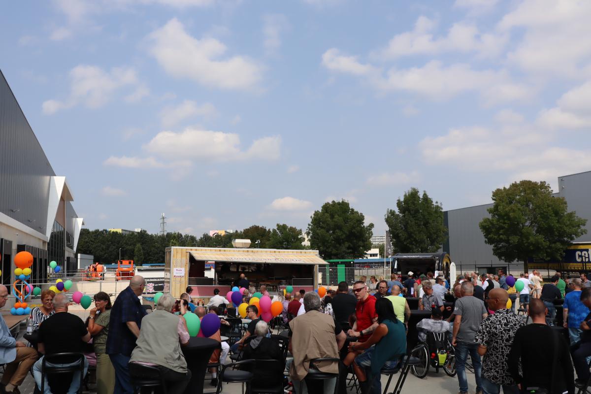 Gezellige samenkomst op parkeerterrein met mooi weer en foodtrucks